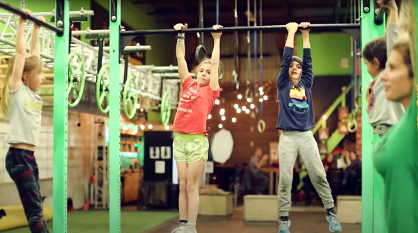 Kids hanging on monkey bars